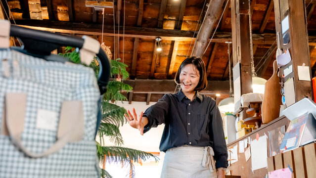 Smiling barista in rustic Korean coffee shop