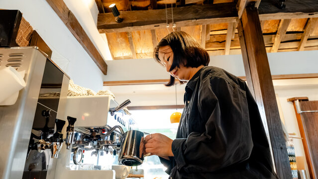 Barista crafting coffee in a cozy South Korean cafe