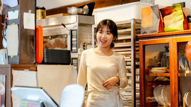 Barista smiles in a cozy Korean coffee shop setting