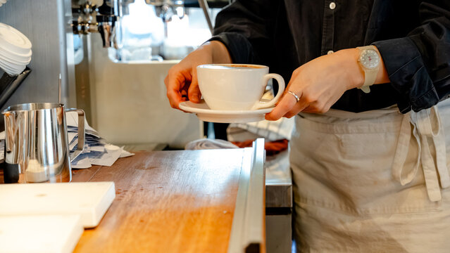 Barista serving coffee in cozy South Korean cafe