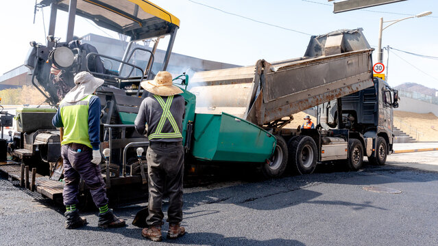 Workers paving street with asphalt in Gyeongju, South Korea