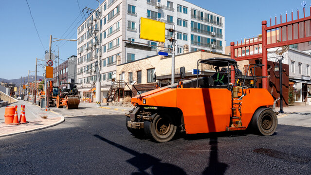 Urban road repair with asphalt paving machinery