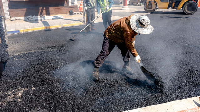 Workers paving a street in South Korea