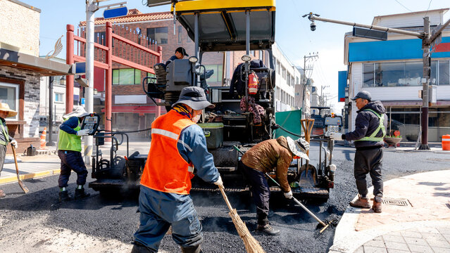Workers paving a street in Gyeongju, South Korea