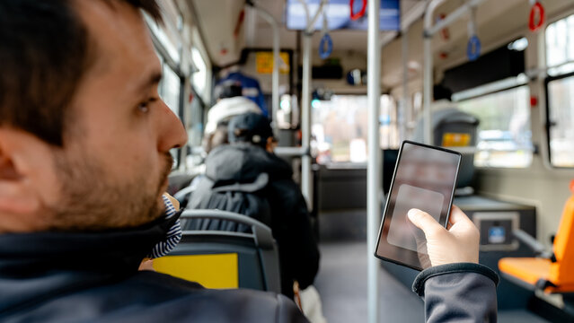 Man using smartphone on bus in Seoul, South Korea