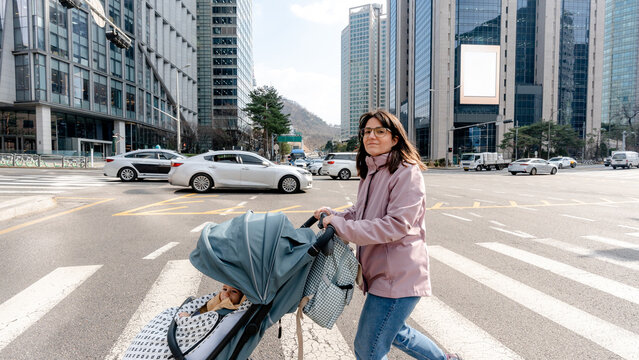 Woman crossing street in Myeongdong with stroller