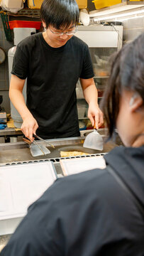 Taiwanese night market vendor cooking scallion pancake