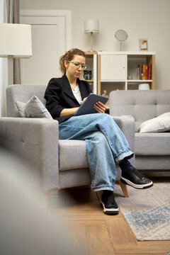 Confident Freelancer Managing Tasks on Digital Device