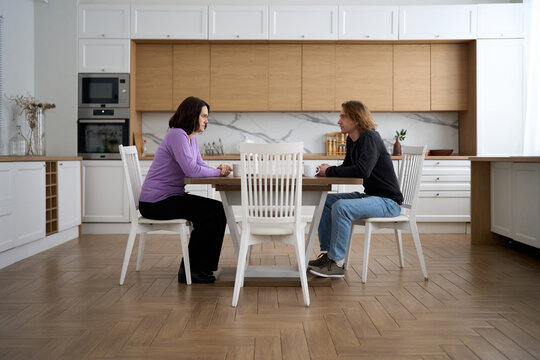 Couple having serious conversation at kitchen table
