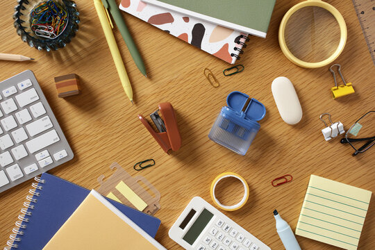 Contemporary home office stationery flat lay on wooden desk