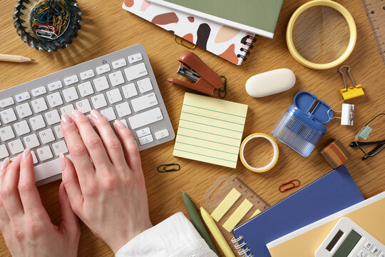 Home office desk flat lay with keyboard and stationery
