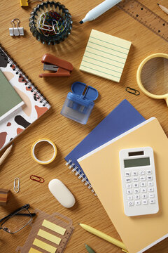 Contemporary office stationery flat lay on wooden desk