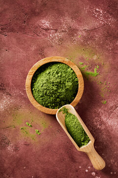 Ceremonial grade matcha powder in bowl with scoop