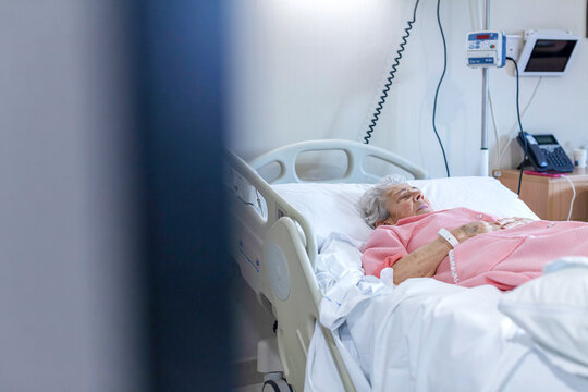 Senior patient resting in a hospital bed receiving care