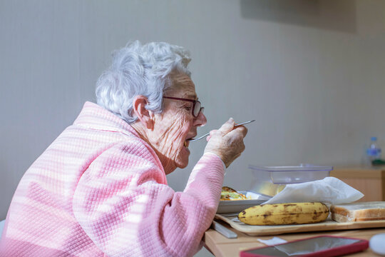 Elderly patient enjoying meal in hospital setting
