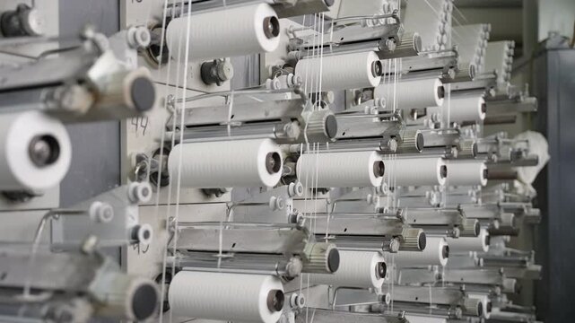 Polypropylene threads winding on industrial weaving loom machine