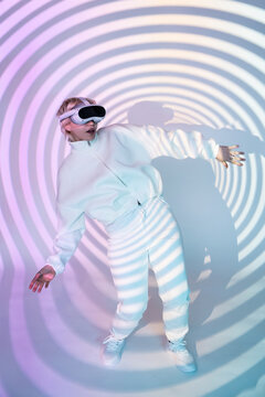 Futuristic woman in VR headset with neon spiral light