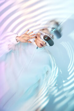 Futuristic woman in VR headset with abstract light ripple