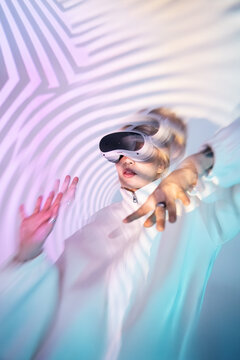 Futuristic woman using VR headset with neon motion blur