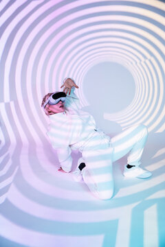Futuristic woman in white VR visor with neon tunnel light