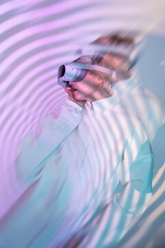 Futuristic woman in VR headset with neon ripple light