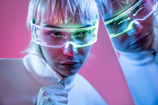 Futuristic woman in neon visor with holographic interface