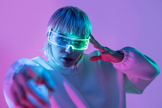 Futuristic woman in neon visor with cyberpunk lighting