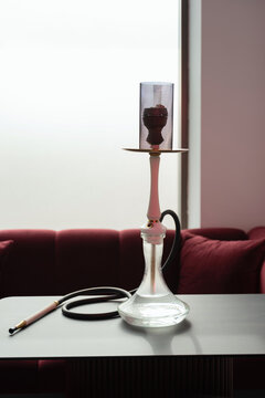 Elegant hookah on table in modern bar setting