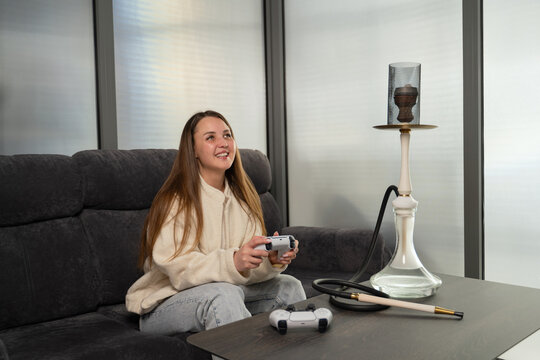 Girl enjoying gaming with hookah in relaxed setting