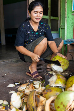 Indonesian Muslim woman preparing coconut street food