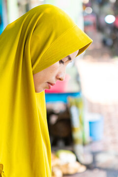 Muslim woman wearing a bright yellow hijab