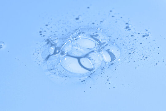Blue gel shower texture with bubbles on clean background
