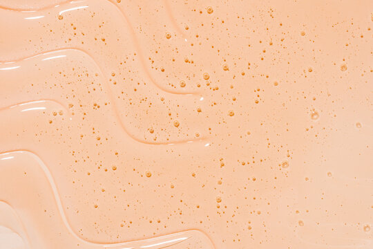 Peach gel shower texture background with bubbles and sparkles
