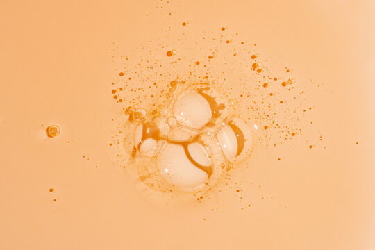 Orange gel shower texture with bubbles on soft background
