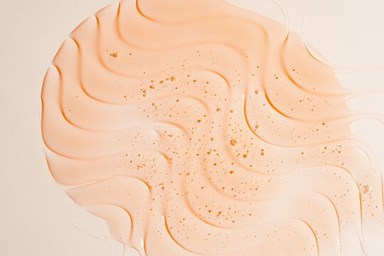 Peach gel shower texture background with smooth swirl pattern