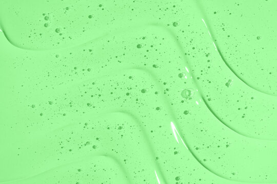 Green gel shower texture background with bubbles and swirls