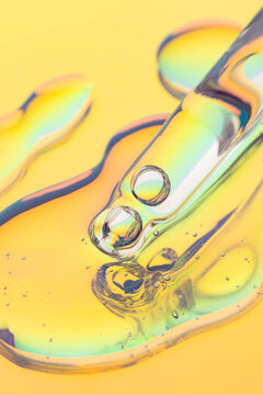 Cosmetic serum dropper with neon glow and glossy texture