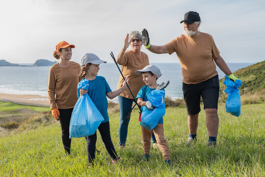 Family volunteering for coastal cleanup to protect nature