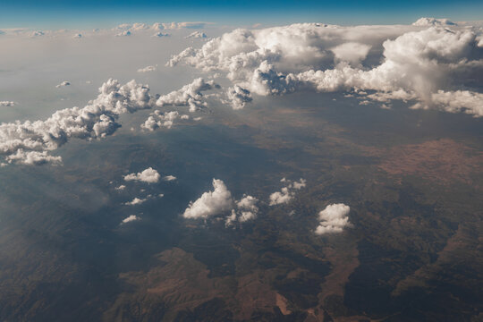Aerial view of dramatic cloudscape above rugged landscape