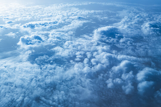Aerial cloudscape above Earth with soft blue atmosphere