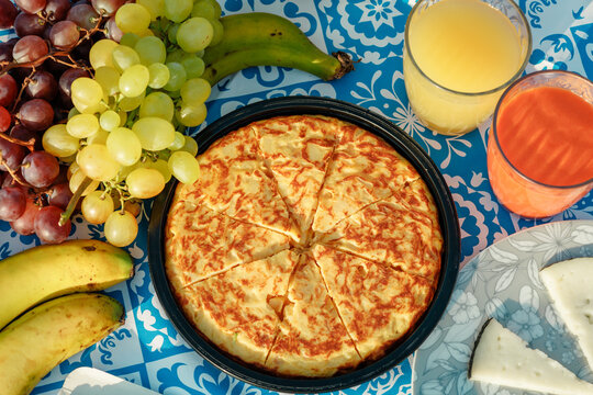Summer picnic spread with tortilla, grapes, banana and juice
