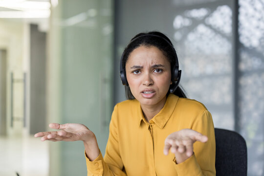 Confused customer support agent shrugging on video call