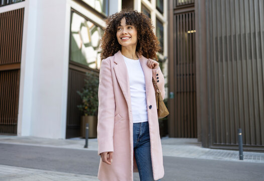 Confident woman enjoying a city stroll in style