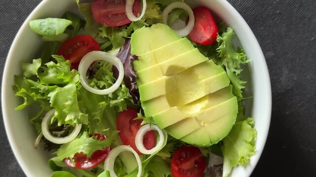 Avocado salad vegetables, tomato, green lettuce tasty snack fresh delicious gourmet food, background on the table rustic food top view copy space keto and paleo diet vegetarian and vegan food