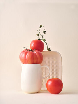 Minimalist studio still life with tomatoes on neutral backdrop