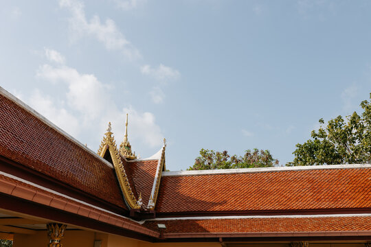 Tropical Thai temple roof architecture under blue sky