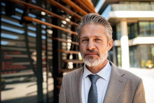 Confident mature businessman outside modern office building