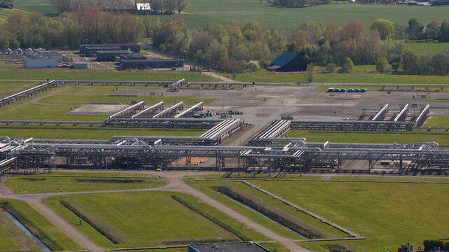 Aerial view of NAM Grijpskerk UGS facility with industrial pipelines, storage infrastructure, and surrounding green fields Grijpskerk, Groningen, Netherlands.