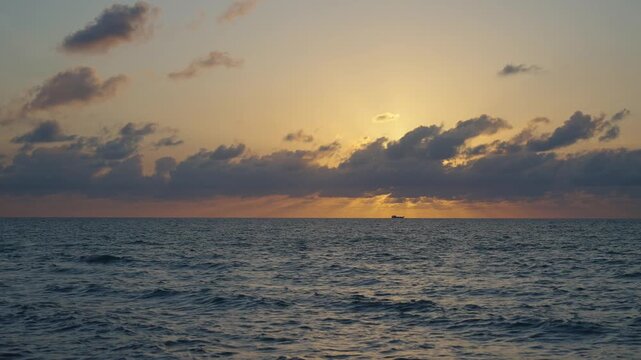 Sunrise seascape. Romantic summer vacation seascape. Sea sunset horizon. Sunset cloudy sky. Seascape at summer vacation. Skyscape with sea horizon. Horizon sunrise sea with ship. 4k footage