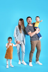 Fototapeta premium Portrait of happy family on light blue background